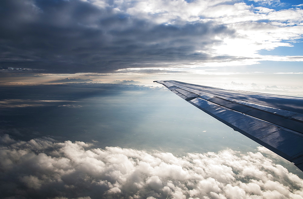 A Commercial Jet Flies Through The Clouds, Colorado, United States Of America