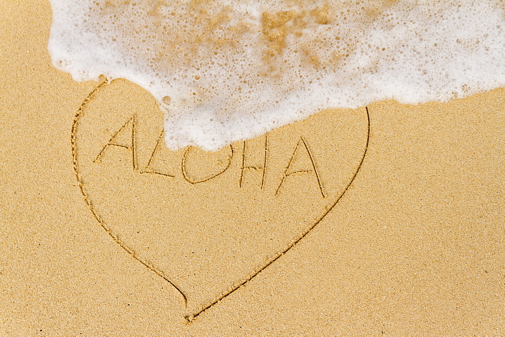 Ocean Water Washing Over A Heart Drawn In The Sand With The Word Aloha, Honolulu, Oahu, Hawaii, United States Of America