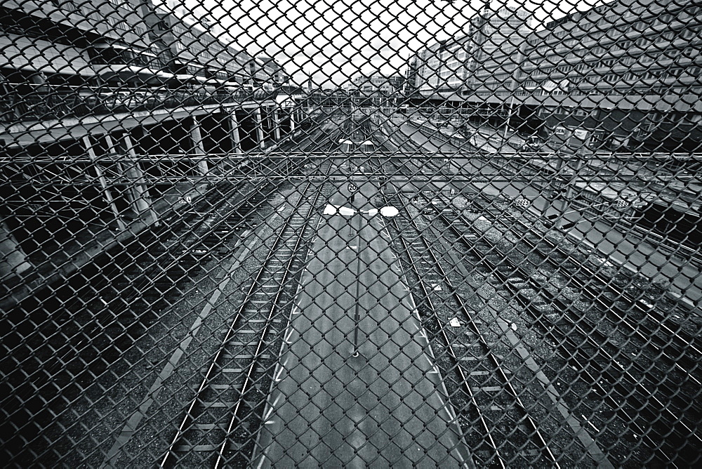 Train Tracks Seen Through Chain Link Fence, Stockholm, Sweden