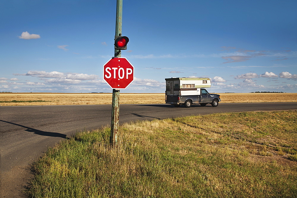 A Stop Sign And Red Light At An Intersection, Saskatchewan, Canada