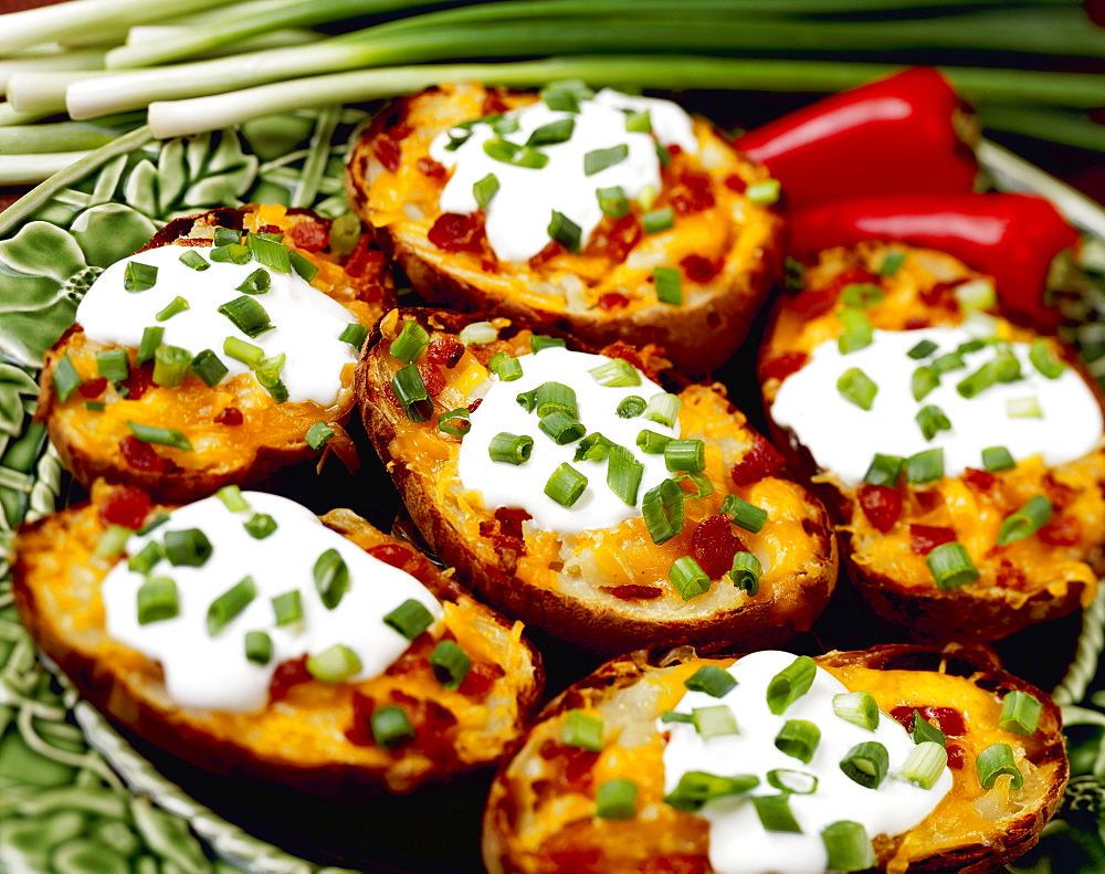 Food - Twice-baked Potatoes with Bacon, garnished with chopped green onions (scallions), enchilada sauce and red chili peppers.