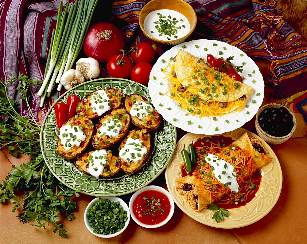 Food - Prepared dishes garnished with chopped green onions (scallions), including Chicken and Cheese Enchilada, Cheese and Mushroom Omelet, and Twice-Baked Potatoes with Bacon.