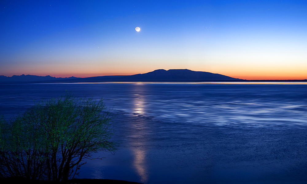 Moon Setting Over Mt. Susitna, Also Known As Sleeping Lady, West Of Anchorage, Alaska, United States Of America