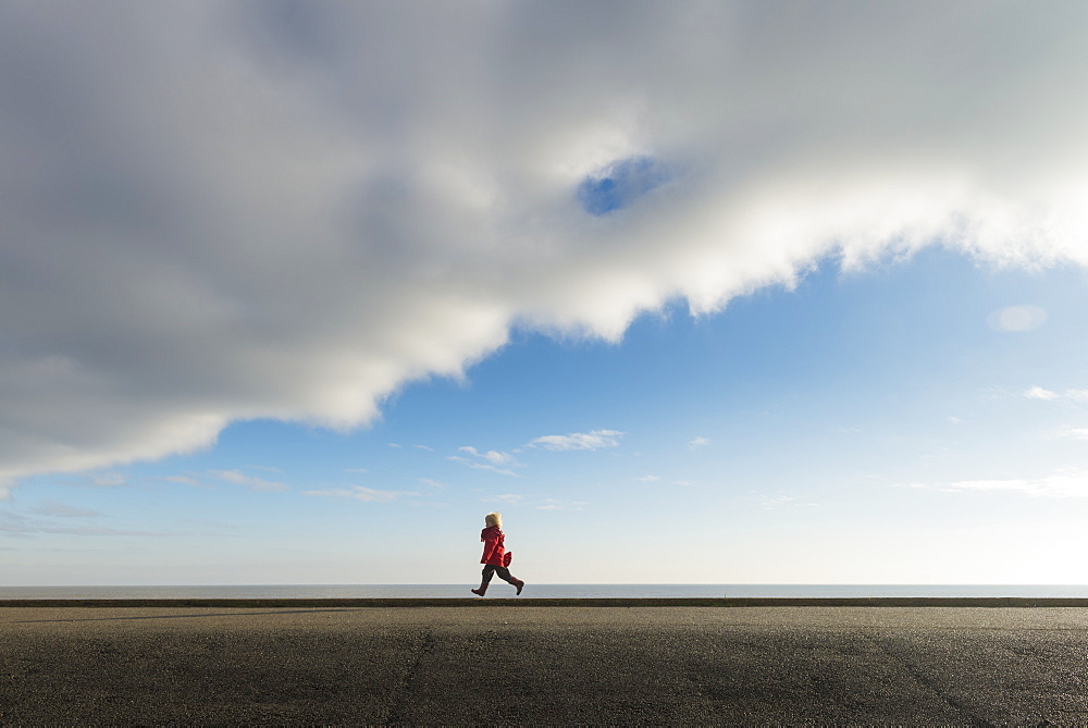 Boy Running Along Sea Wall, Aldeburgh, Suffolk, England