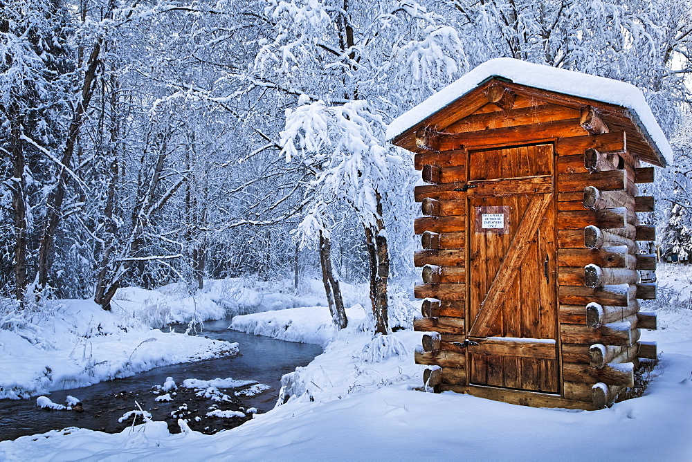 Log Outhouse By A Meandering Creek In Snow, Chena Hot Springs Resort, Fairbanks, Alaska, United States Of America