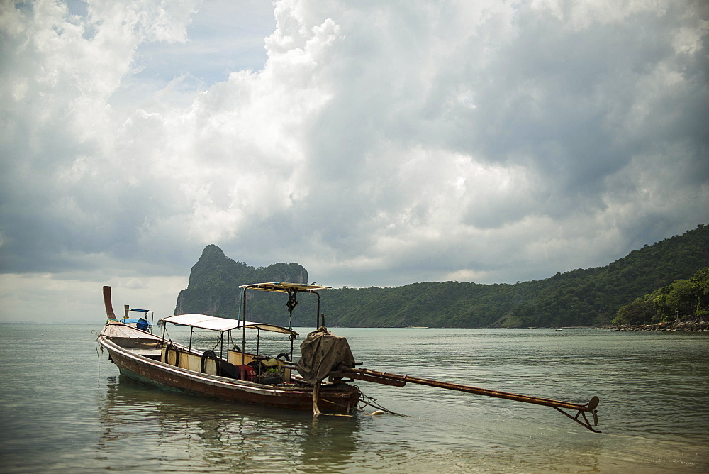 A Fishing Boat Sits In The Main Bay Of Koh Phi Phi Island In The Andaman Sea, Thailand