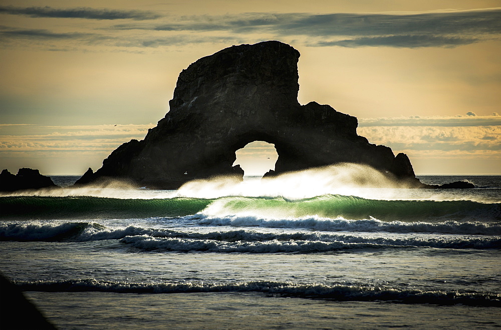 Surf Breaks Near A Natural Arch, Cannon Beach, Oregon, United States Of America