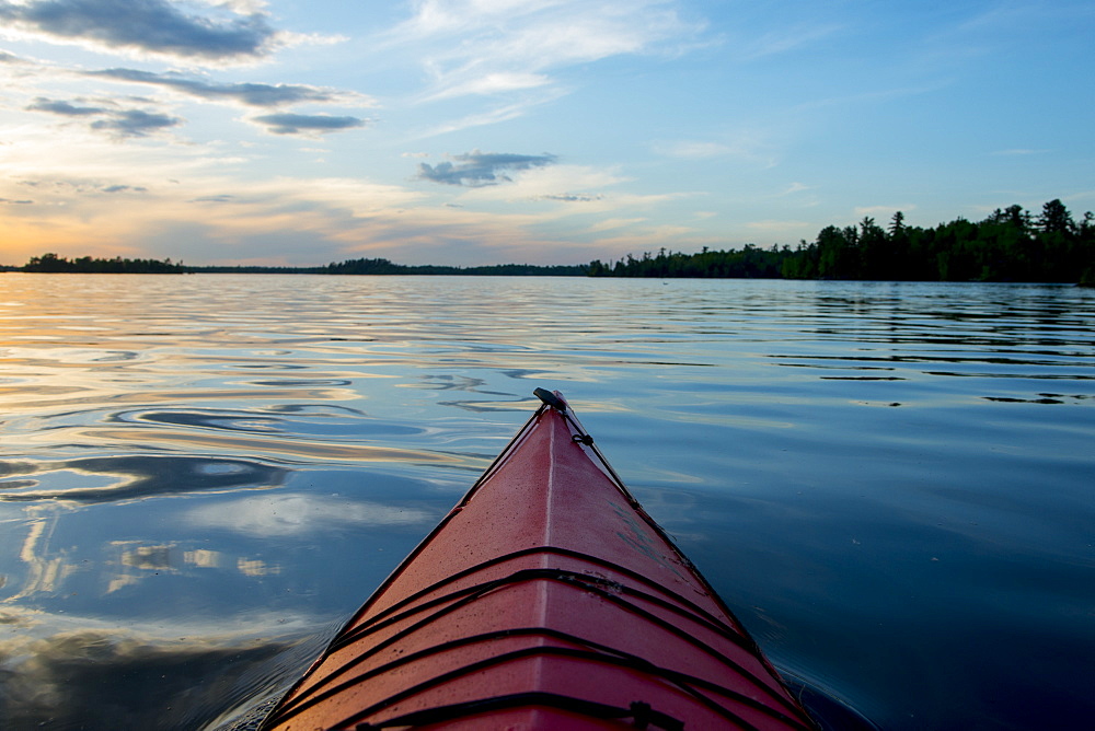 Bow Of A Canoe On A Tranquil Lake At Sunset, Ontario, Canada