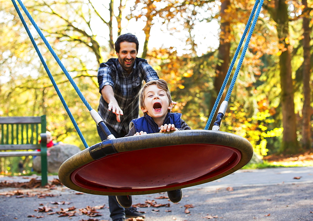 Father And Son Having Fun Together At A Playground, Langley, British Columbia, Canada