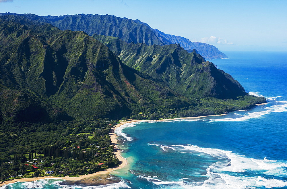 Rugged Mountains Along The Coastline And The Surf Meets The Beach, Haena, Hawaii, United States Of America