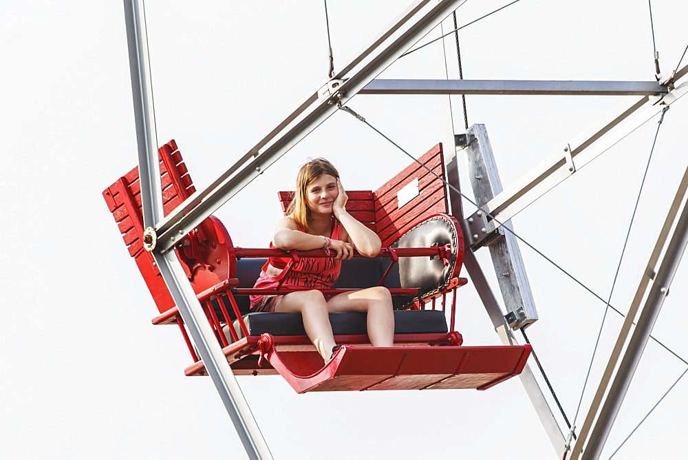 A Pre-Teen Girl Waiting Patiently For The Ferris Wheel To Load, Edmonton, Alberta, Canada