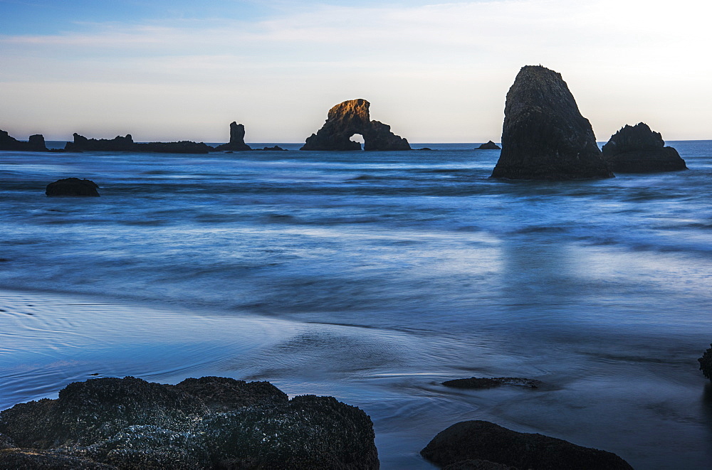 The Sun Comes Up On Sea Stacks, Cannon Beach, Oregon, United States Of America