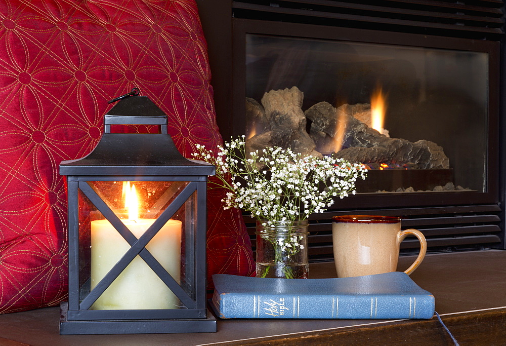 A Bible, Candle And Mug Sit On The Fireplace Hearth, Yarrow, British Columbia, Canada