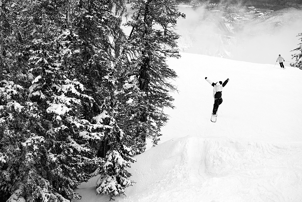 Person In Air After Making A Jump While Snowboarding, Aspen, Colorado, USA