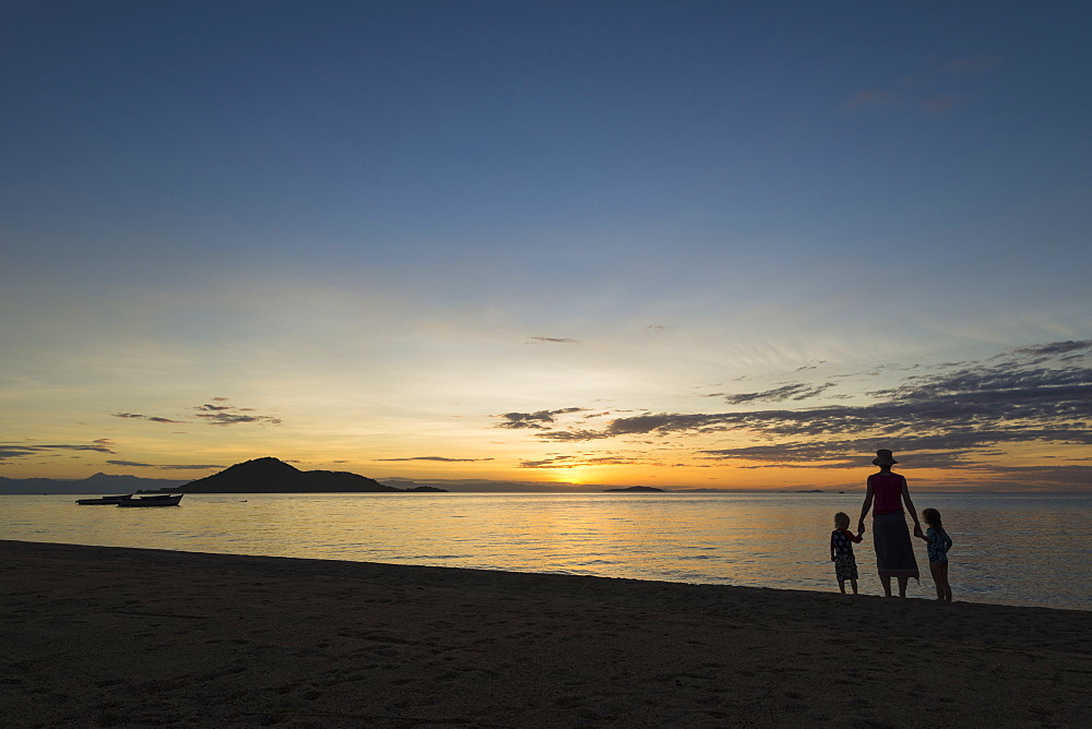 Silhouette Of Mother With Boy And Girl On Beach At Cape Maclear At Sunset, Lake Malawi, Malawi