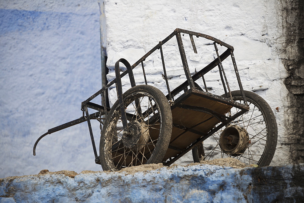 Old Cart Resting Amongst Faded Blue And White Painted Buildings, Chefchaouen, Morocco