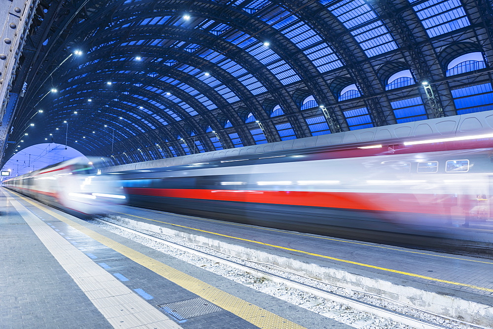 Motion Blur Of Speeding Train In Train Station, Milan, Lombardy, Italy