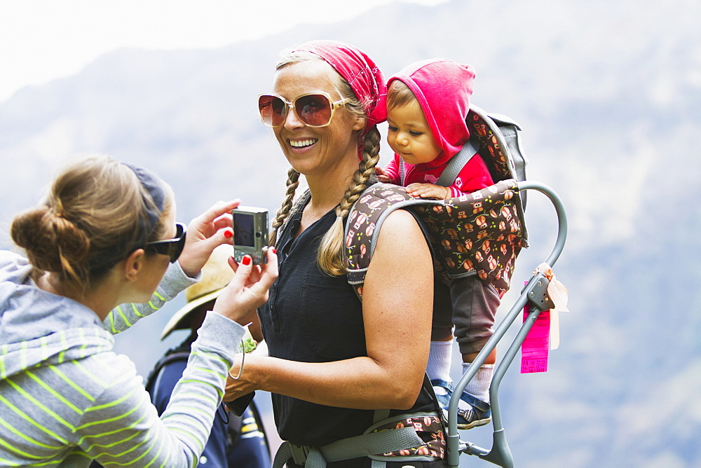 A Family Overlooks The Breathtaking Views Over Waimea Canyon, Kauai, Hawaii, United States Of America