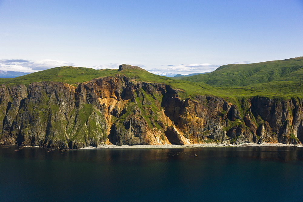 Aerial View Of Rocky Cliffs And Green Hills Along The Shore Of Popof Island Near Sand Point, Southwestern Alaska, USA, Summer