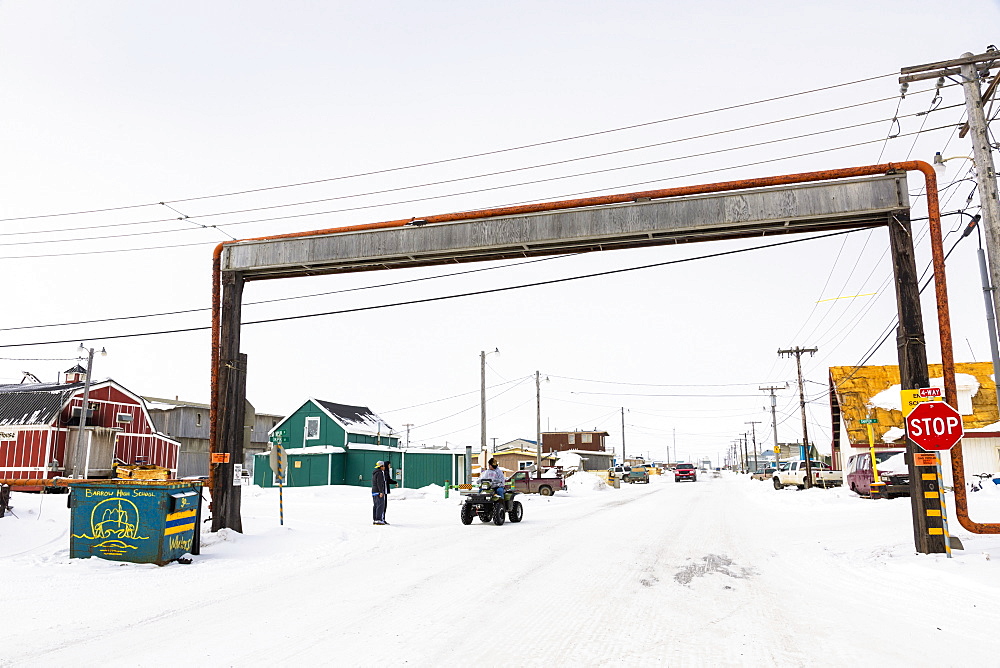 A Barrow Resident On An Atv Stops At A Above Ground Utilities Bridge, Barrow, North Slope, Arctic Alaska, USA, Winter