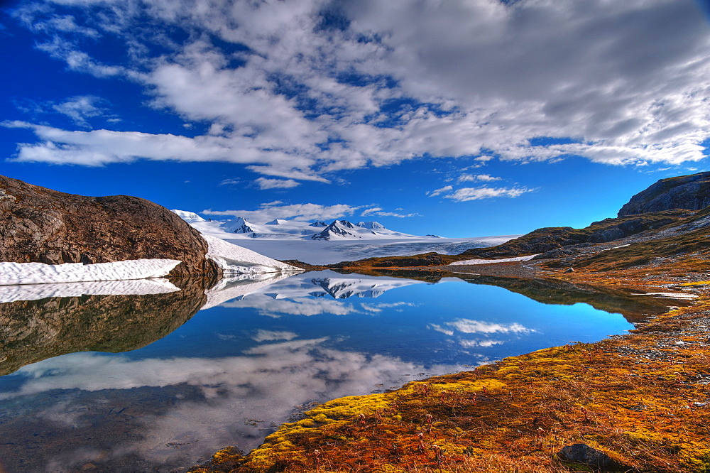 A Crystal Clear Lake Near The Harding Icefield Trail With The Harding Ice Field In The Background, Kenai Fjords National Park, Alaska, United States Of America