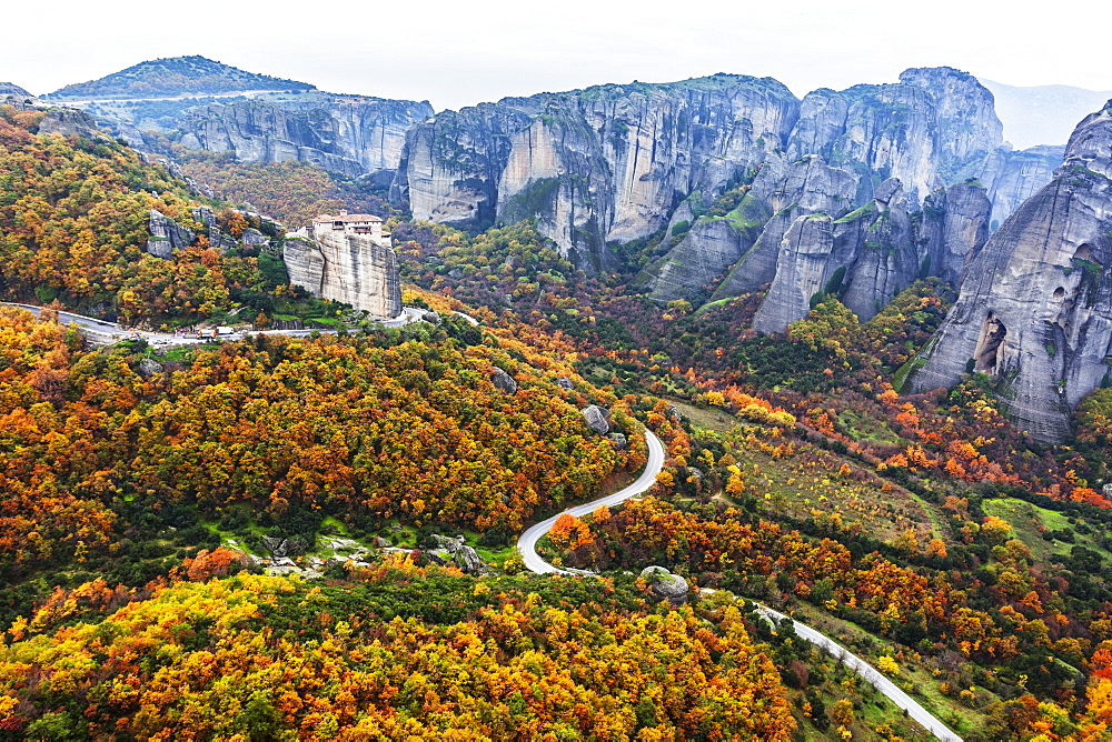 Monastery Perched On A Cliff With Autumn Coloured Foliage, Meteora, Greece