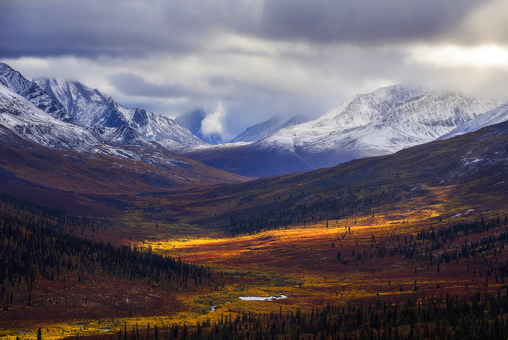 Storm Clouds Part Allowing Light To Illuminate The Landcape In The North Klondike Valley Along The Dempster Highway In Northern Yukon, Yukon, Canada