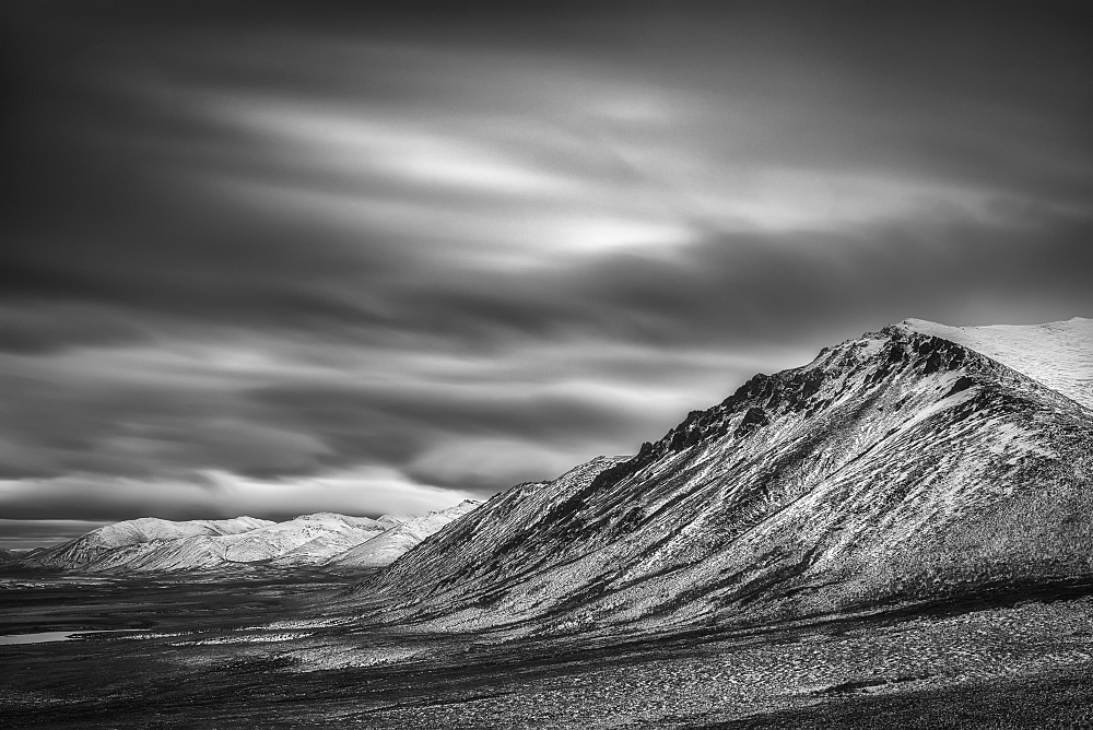 Black And White Long Exposure Of Clouds Over The Cloudy Range Along The Dempster Highway, Yukon, Canada