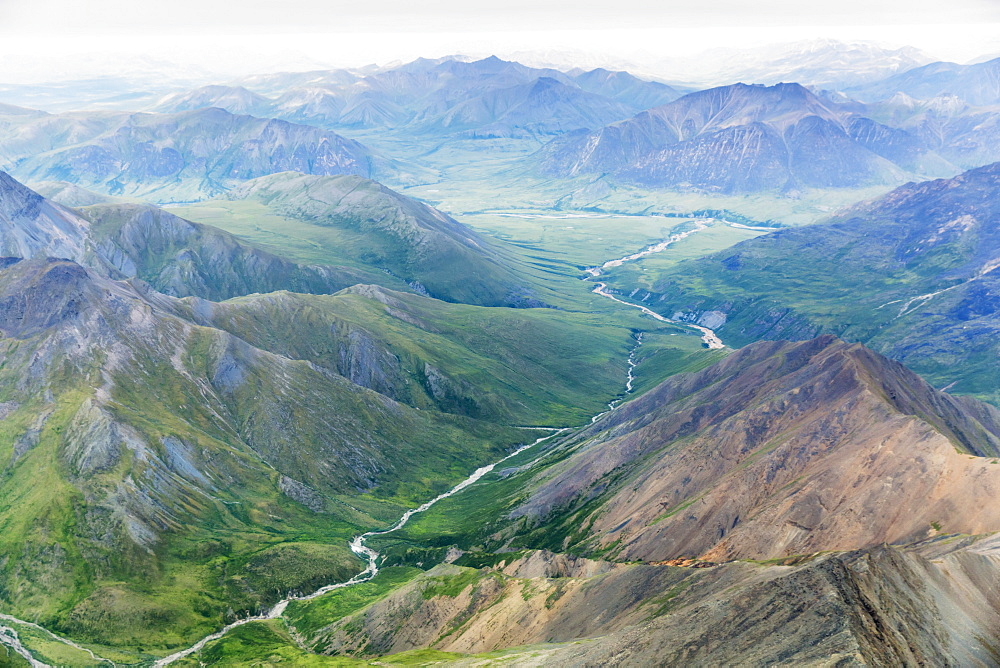 Aerial View Of A River Cutting Through A Valley In The Brooks Range, Alaska, United States Of America