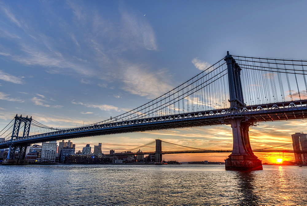 Sun Setting Behind Manhattan And Brooklyn Bridges, New York City, New York, United States Of America