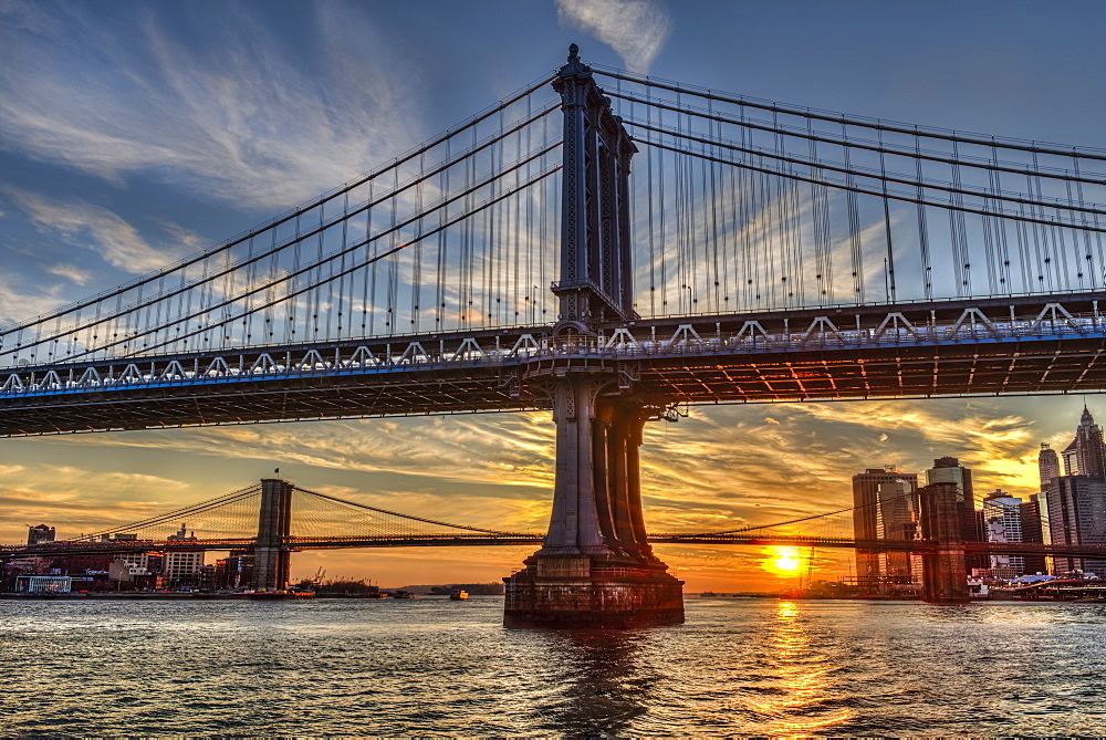 Sun Setting Behind Manhattan And Brooklyn Bridges, New York City, New York, United States Of America