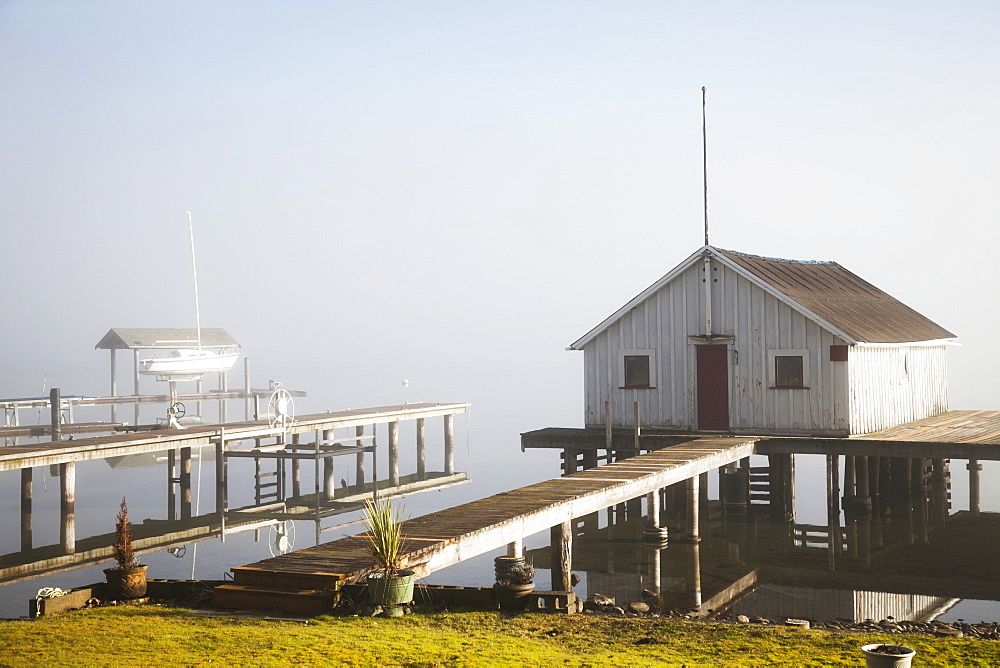 Boathouse And Sailboat On Foggy Lake, Bellingham, Washington, United States Of America