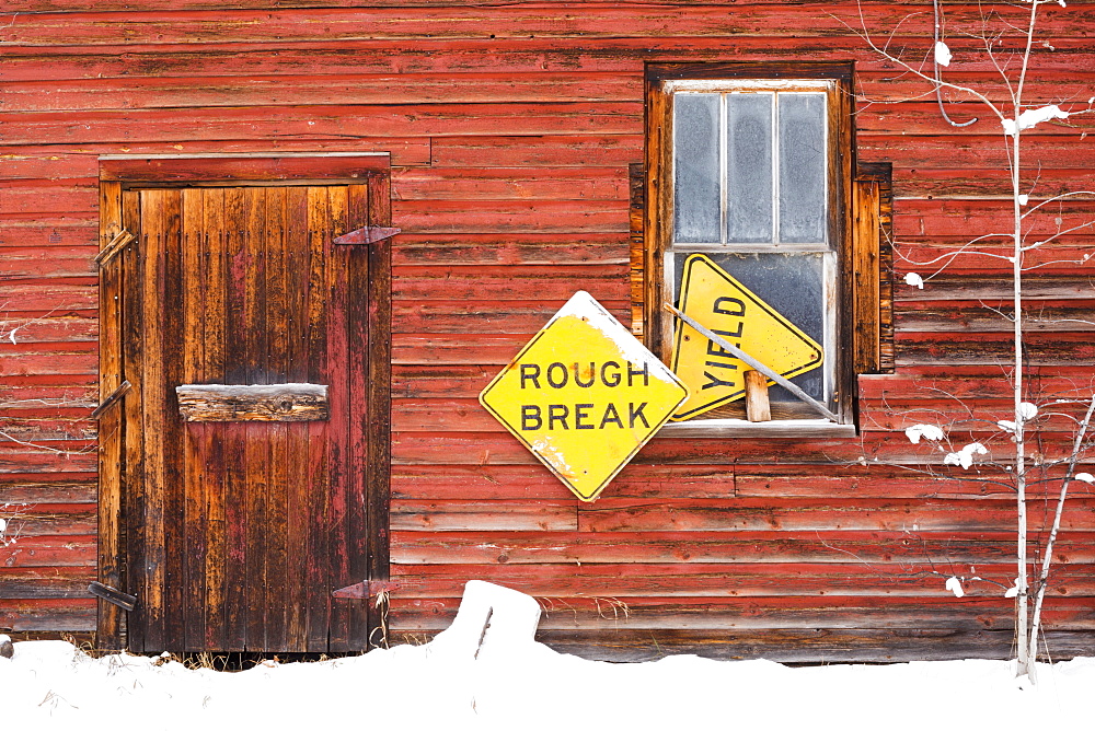 A Red Wooden Building With Two Yellow Signs, Saying 'rough Break' And 'yield', Wetaskiwin, Alberta, Canada