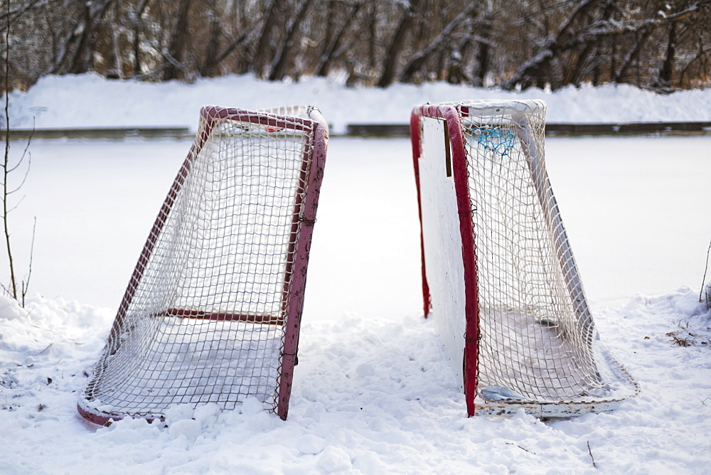 Two Hockey Nets In The Snow Beside A Frozen Outdoor Rink, Wetaskiwin, Alberta, Canada