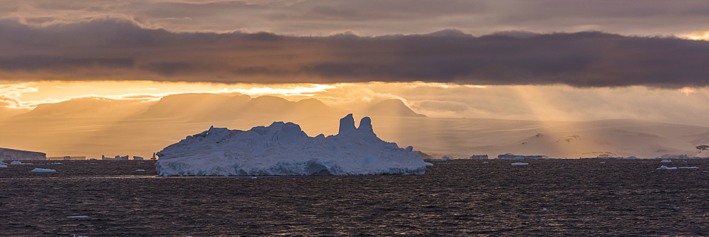 Jagged Iceberg In Silhouette Against Dawn Sky, Antarctica