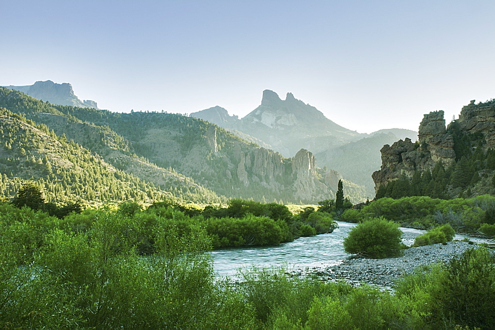 The Early Morning Sun Illuminates A Green River Valley And Sharp Mountain Peaks, Argentina