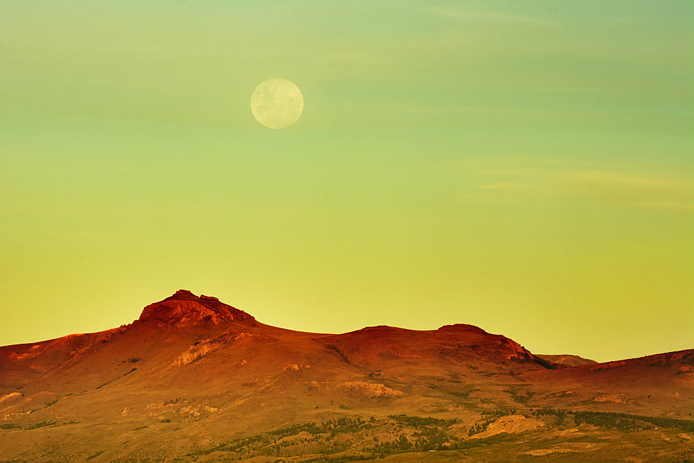 The Moon Is Rising Over A Yellow Desert Landscape, Bariloche, Argentina