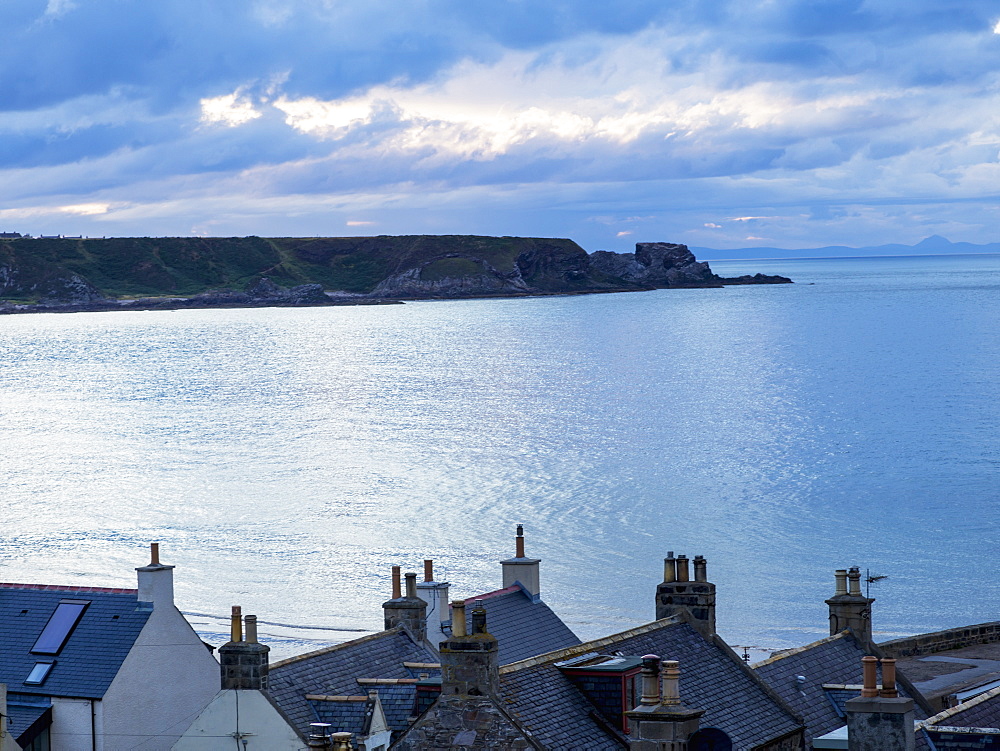 Cliffs Along The Coastline And Rooftops Of Houses In The Foreground, Cullen, Moray, Scotland