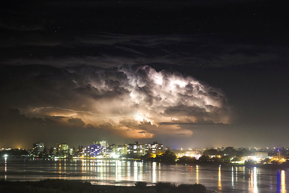 Buildings Along The Coastline Illuminated And Reflected In The Water At Nighttime, Brisbane, Queensland, Australia