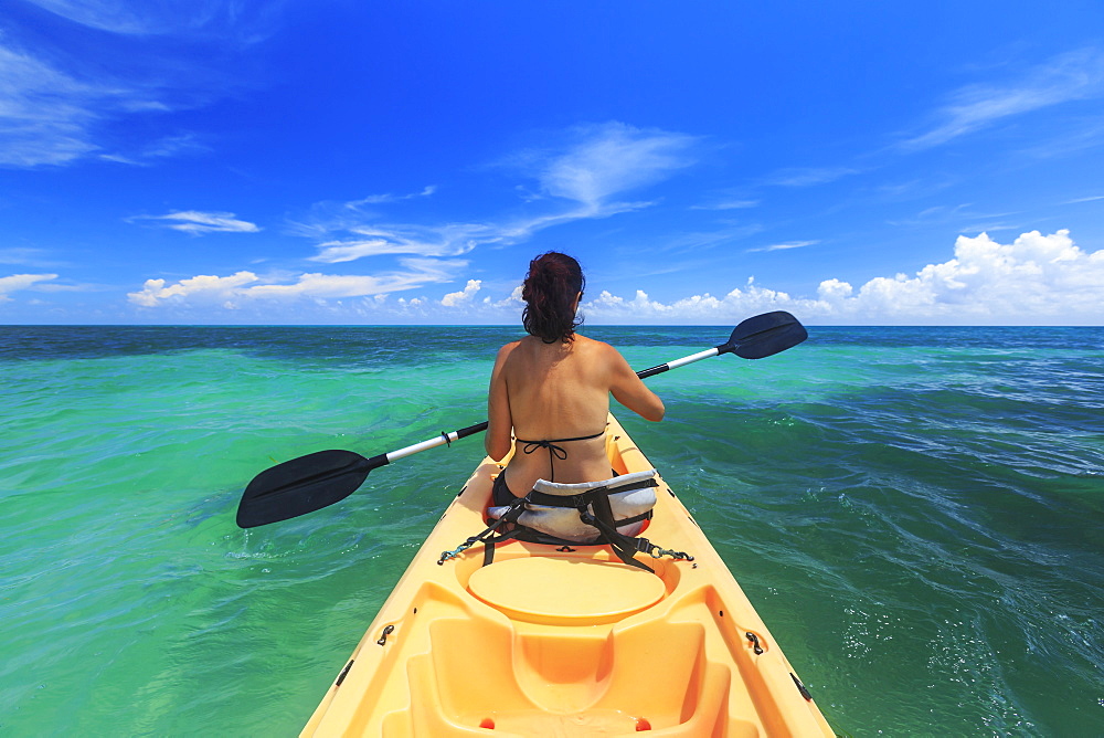 A Woman In A Bikini In A Kayak On The Caribbean, Saint Georges Caye Resort, Belize City, Belize