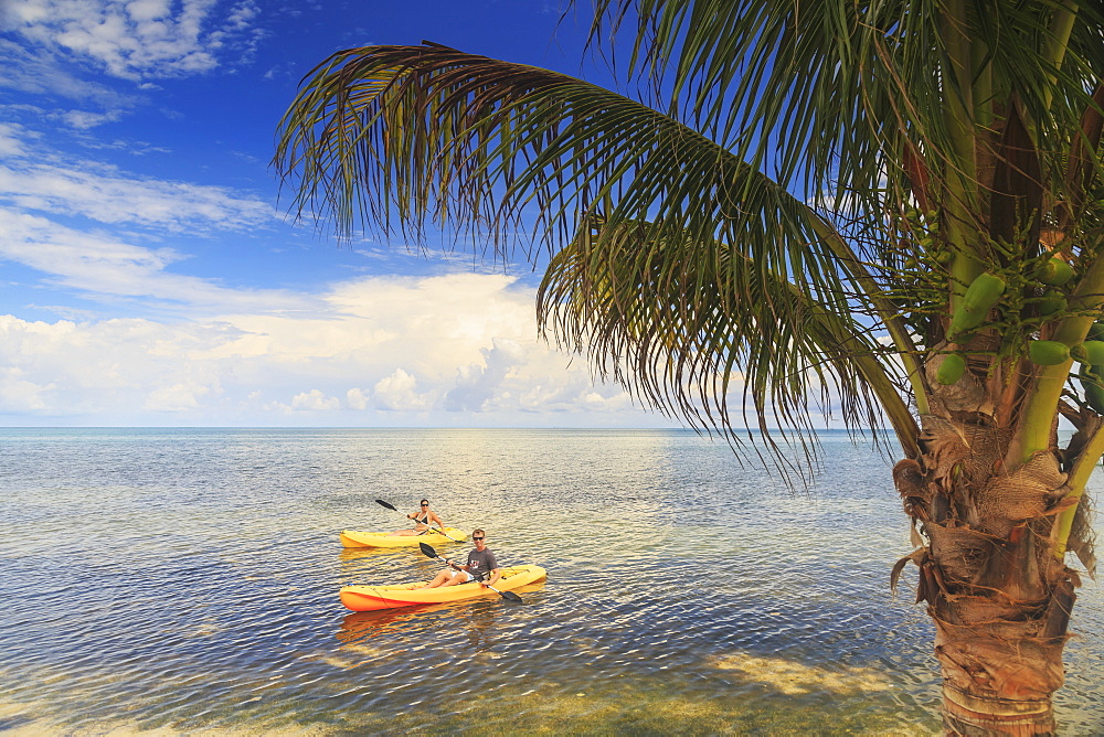 A Couple Using Kayaks At Saint Georges Caye Resort, Belize City, Belize