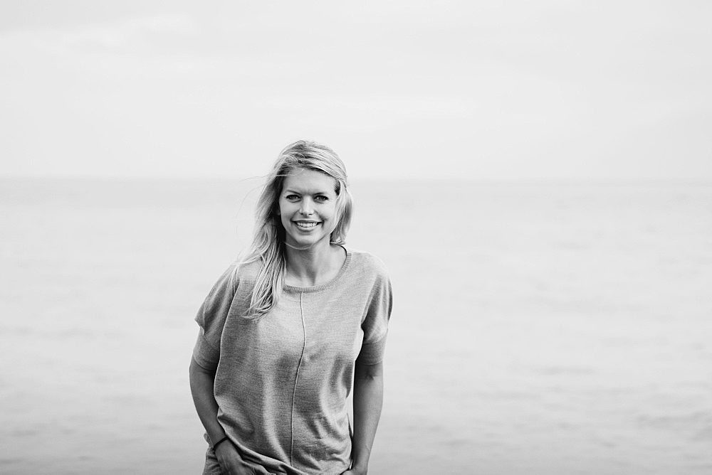 Portrait Of A Young Woman With Long Blond Hair At The Ocean, Hastings, Sussex, England