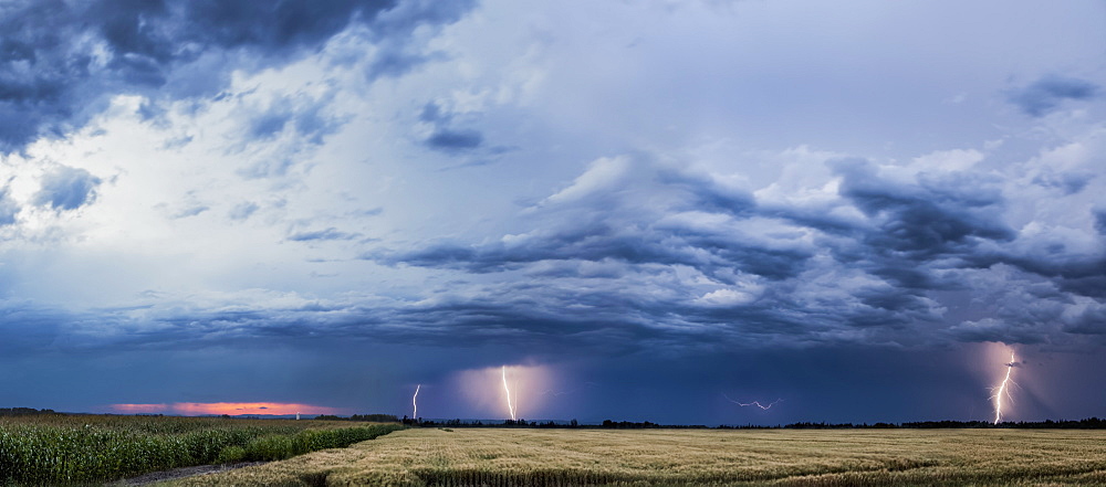 Storm Clouds And Lightning Strikes Over A Rural Landscape, Thunder Bay, Ontario, Canada