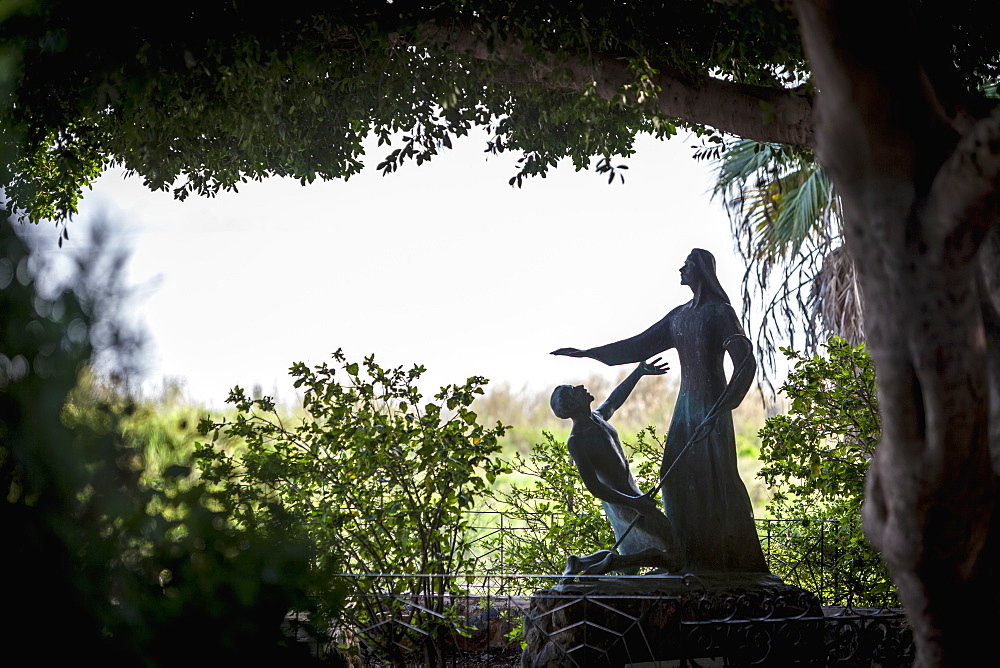 On The Sea Of Galilee, A Statue Beside The Church Of St Peter's Primacy Depicts Jesus After His Death And Resurrection, Appearing Before St. Peter, Galilee, Israel