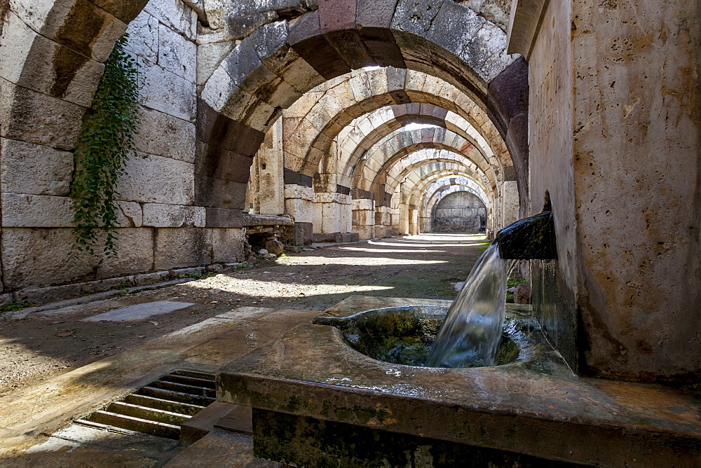 Water Flowing From A Spout In The Wall At The Site Of Ancient Ruins, Smyrna, Turkey