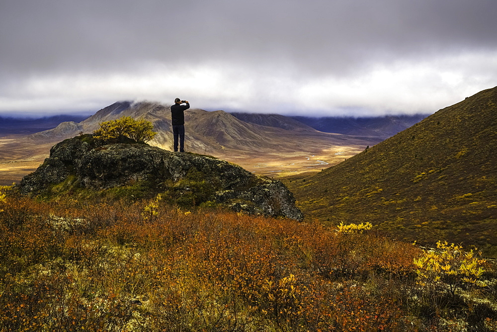 Man Taking Photos On A Smart Phone, Dempster Highway, Yukon, Canada