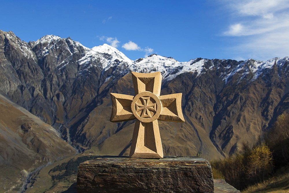 Stone Fountain With A Cross With The Caucasus Mountains In The Background, Kazbegi, Mtskheta-Mtianeti, Georgia