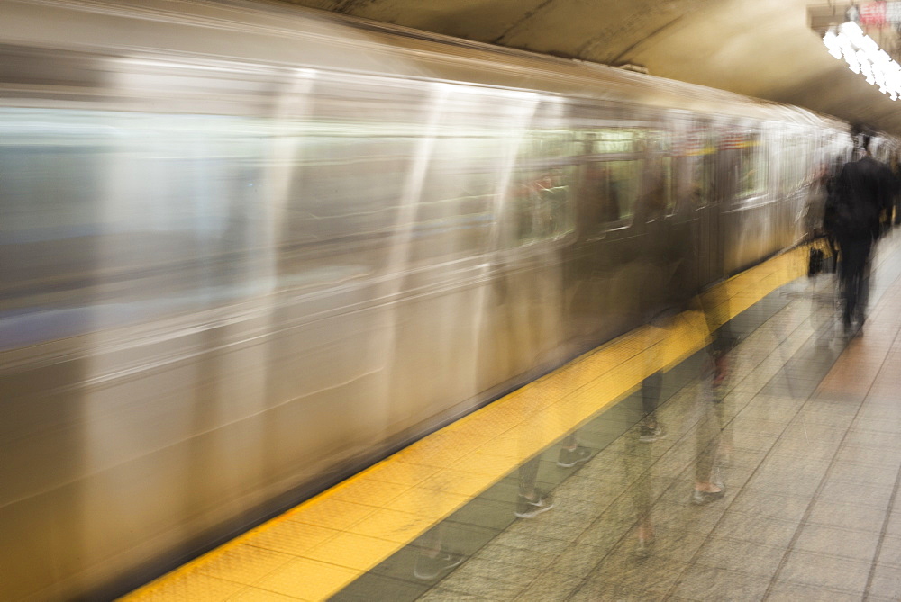 Motion Blur Of Passengers Walking On The Platform Beside The Moving Subway, New York City, New York, United States Of America