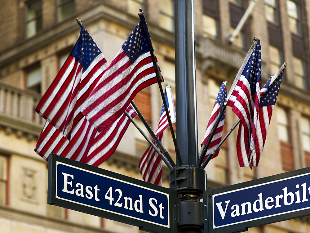 American Flags On A Pole Above The Street Signs At The Intersection Of East 42nd Street And Vanderbilt, New York City, New York, United States Of America