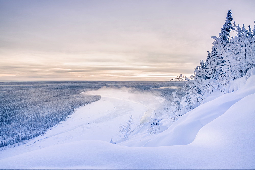 Fog Rises Off Of The Copper River On A Cold Winter Evening, Warm Sunset Light Casting Mount Drum Into Shadows In The Background, Copper River Valley, South-Central Alaska, Alaska, United States Of America